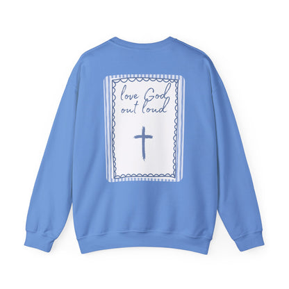 Blue sweatshirt with a cross and text design on the back against a white background